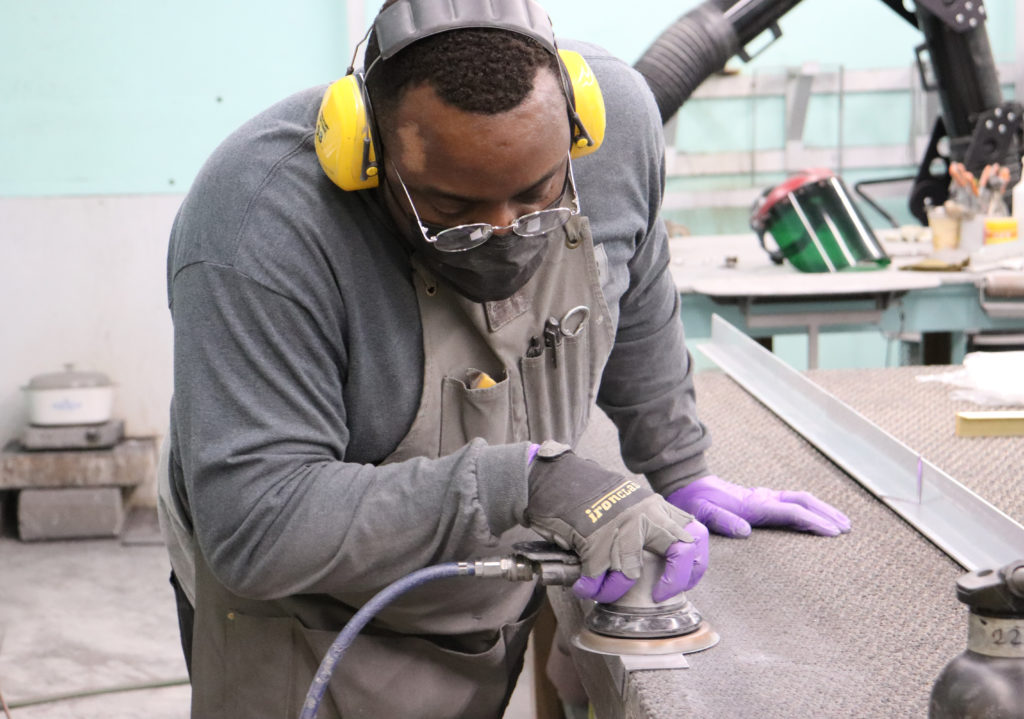 Nate sanding in metal shop.