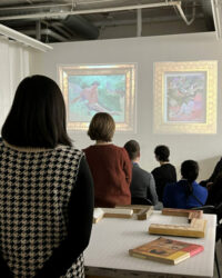 Art collectors looking at slides of museum quality frames.